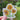 Sticker with sunflower design held by a hand against a blurred natural background