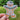 a person holding a gingerbread sticker with holly berry garland on a blurred outdoor background 
