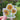 Sticker with sunflower design held by a hand against a blurred natural background